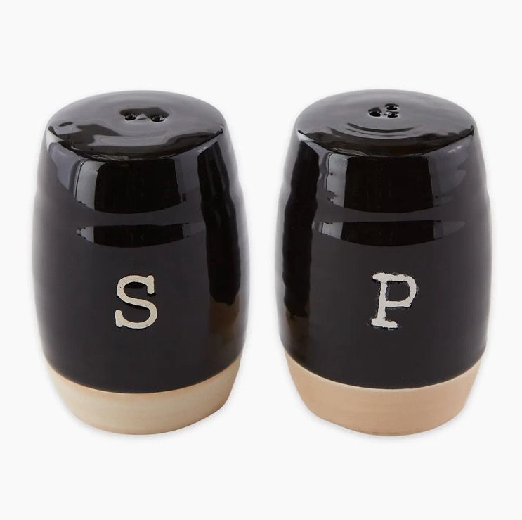A pair of black ceramic salt and pepper shakers with "S" and "P" on front.