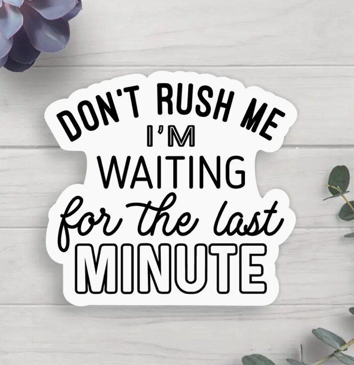 Sticker with the text "DON'T RUSH ME I'M WAITING for the LAST MINUTE" on a white background, surrounded by a gray wooden surface and green leaves.