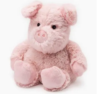 The Pig Warmie, a plush pink toy with small black eyes and a snout, sits upright.