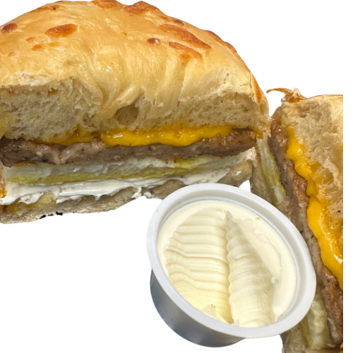 The Breakfast Egg Bagel, filled with egg, sausage, and cheese, is halved. A small cup of butter accompanies it.